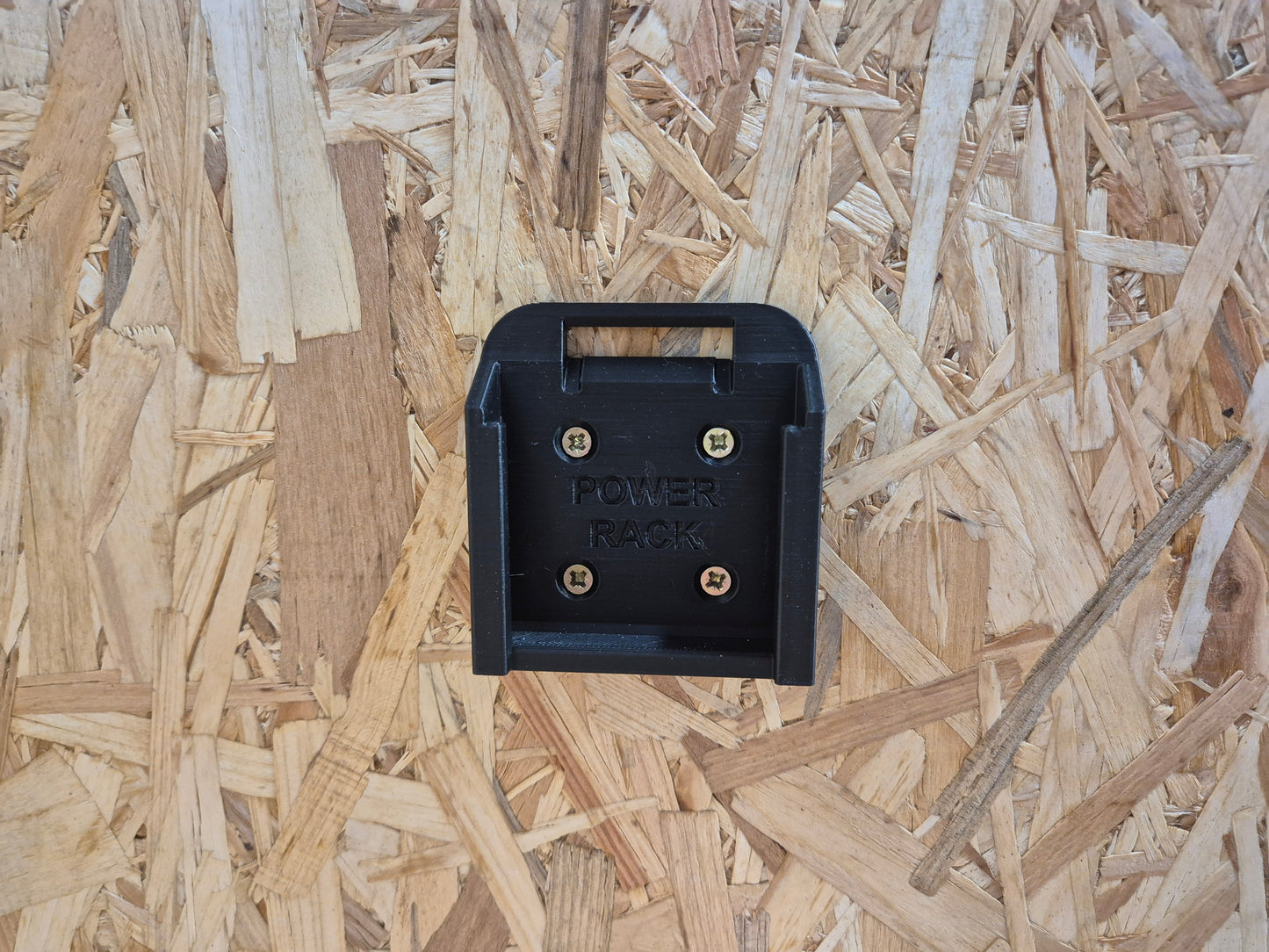 Black Power Rack battery holder for Makita on a wooden surface