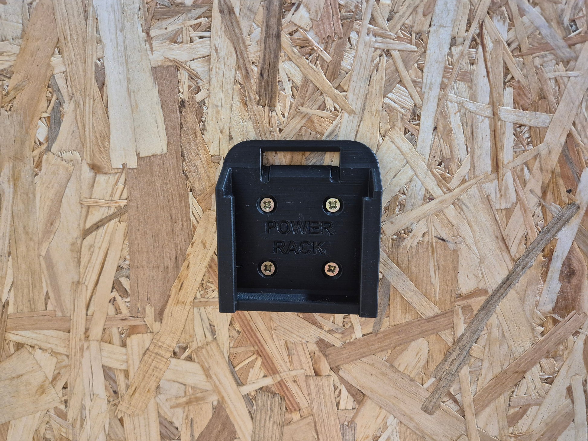 Black Power Rack battery holder for Makita on a wooden surface