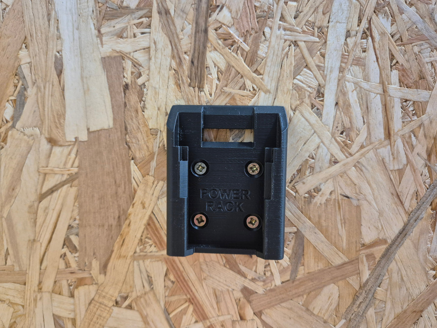 Black power pack click battery mount on a wooden background