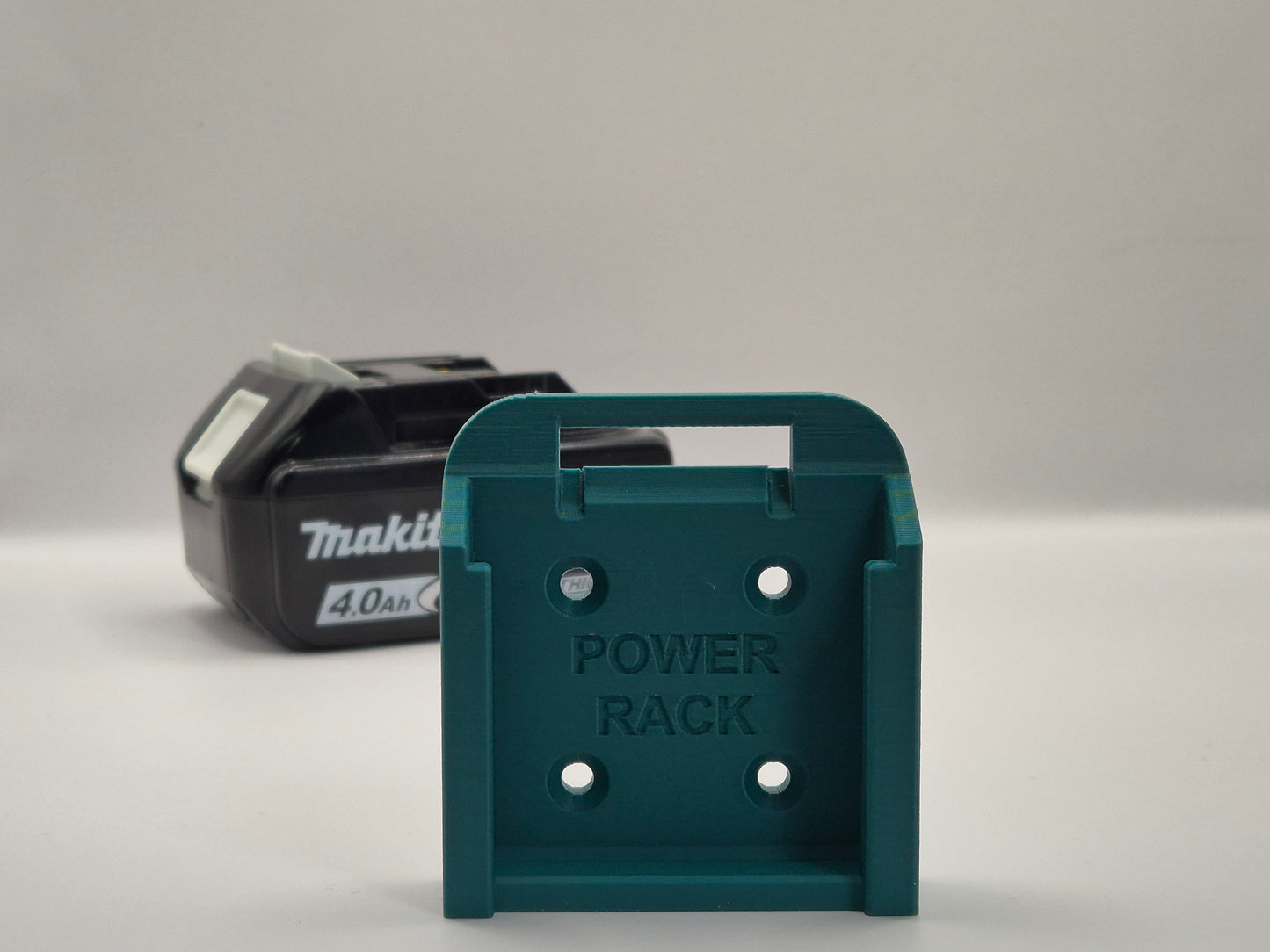 Blue power rack with Makita battery on a grey background