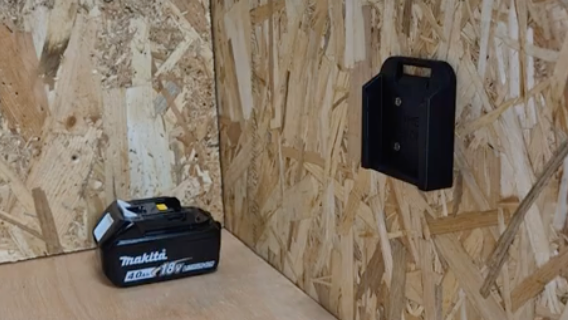 Black battery holder on a wooden panel background