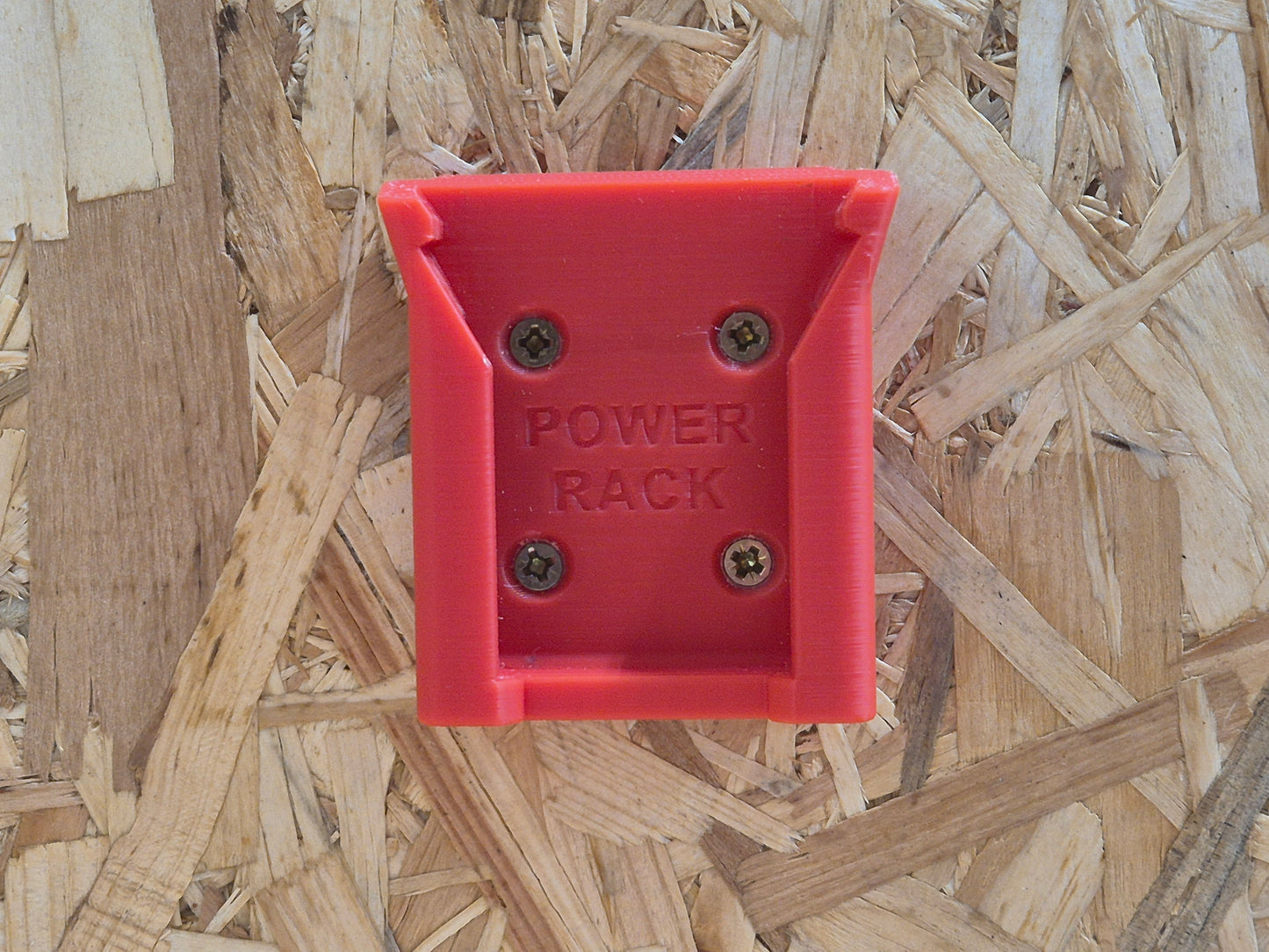 Red Milwaukee power rack battery holder on a wooden background