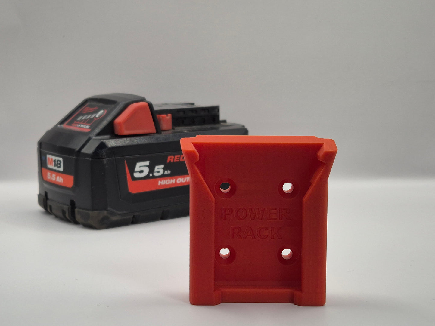 Red battery pack with 'Power Rack battery Mount" branding on a grey background
