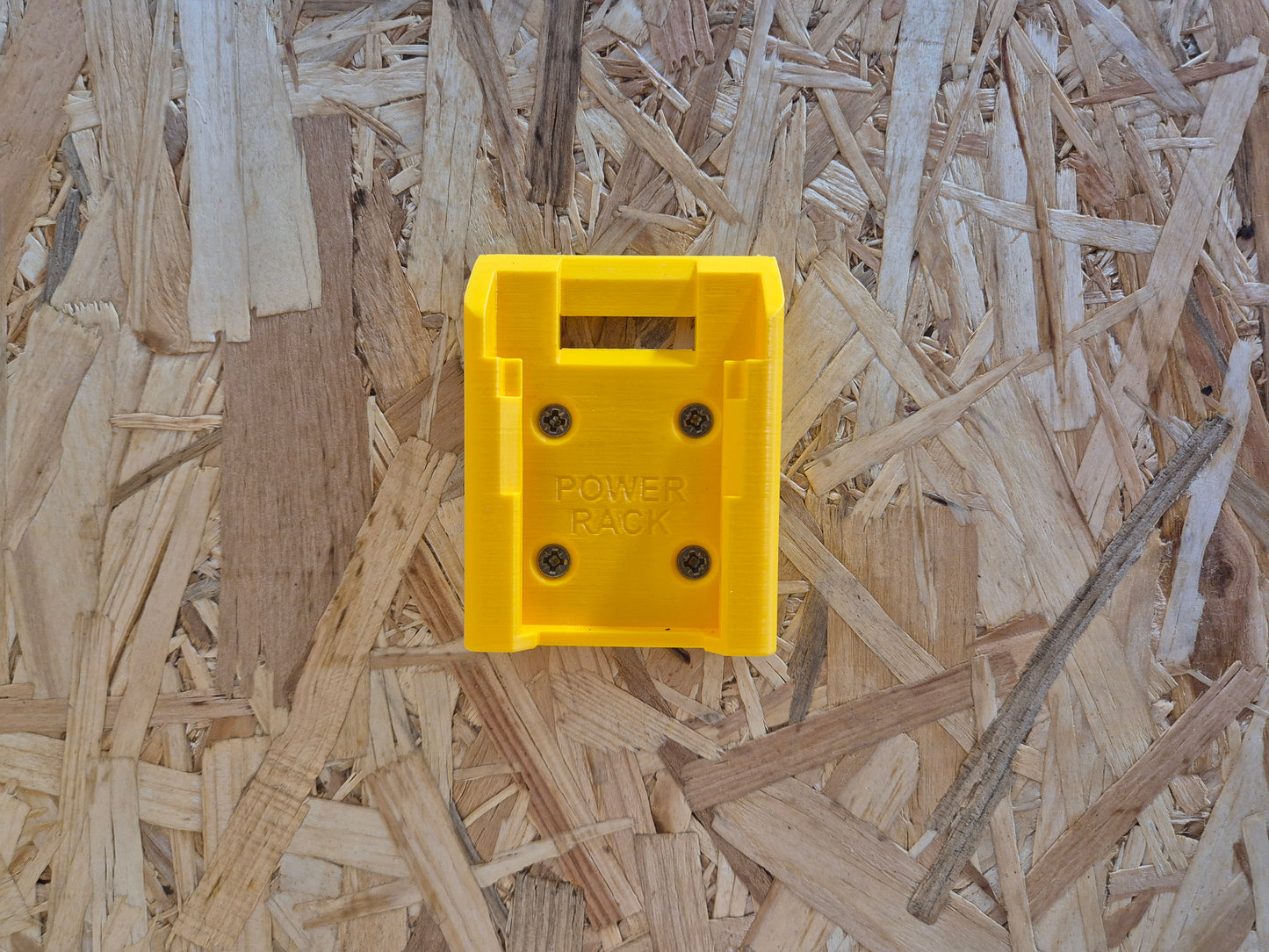Yellow power rack click battery mount on a wooden background
